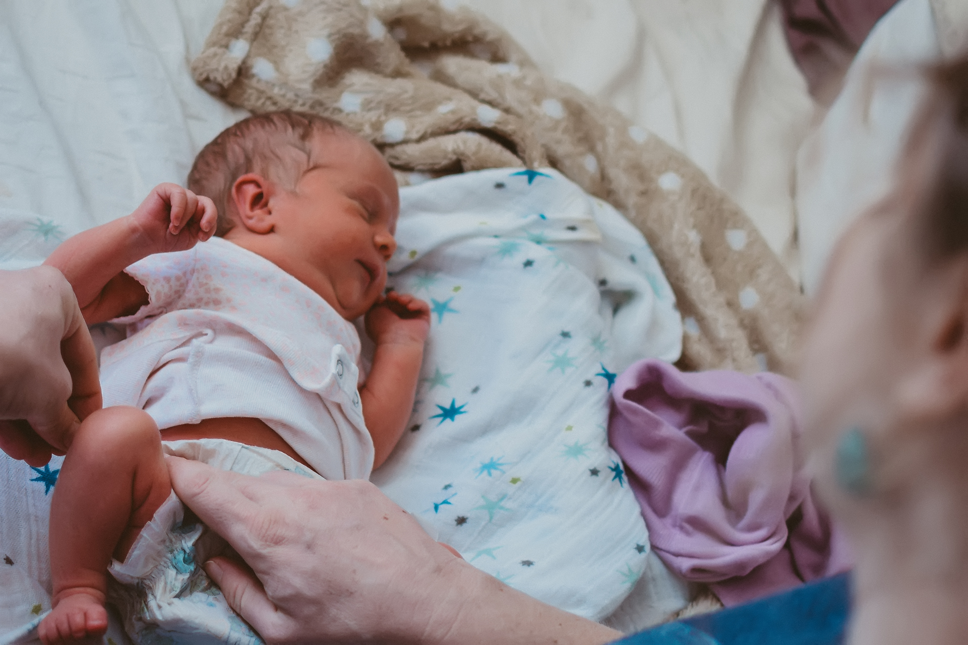 Sleeping baby being cared for by mother, photo by Natalie Broders Sleeping baby being cared for by mother, photo by Natalie Broders