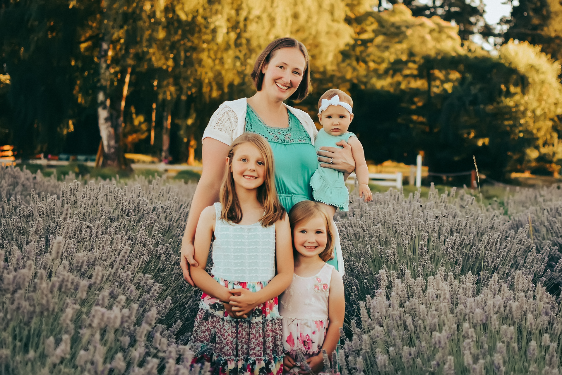 Family portrait of a mother with her three daughters standing in a lavender field on Sauvie Island in Oregon Family portrait of a mother with her three daughters standing in a lavender field on Sauvie Island in Oregon